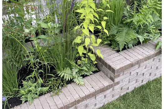 Macmillan Legacy show garden RHS Hampton Court with Aldridge clay paving overhanging rill on 2 levels. Design by Sean Pritchard.