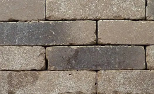 A close-up view of Aldridge clay pavers laid together, highlighting their earthy tones and naturally shaped edges.