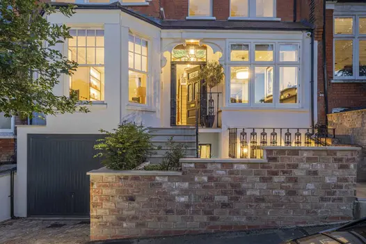Stepped wall outside Edwardian terrace townhouse with Britannia Buff Yorkstone steps up to open front door. Design by All Done.
