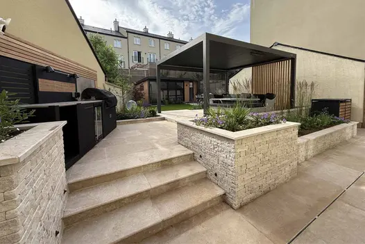 Contemporary garden design by Eliza Gray Gardens using Antique Egyptian Beige limestone paving and raised beds
