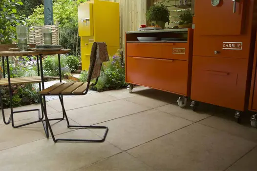 Antique Egyptian Beige Limestone paving with Charlie Charcoal outdoor oven units in a shaded garden kitchen setup.