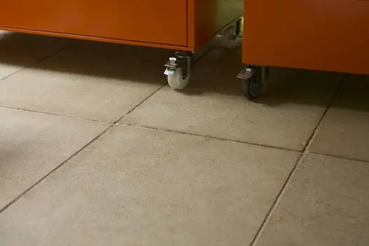Antique Egyptian Beige Limestone slabs forming a warm-toned patio space, partially shaded beneath outdoor cooking station.