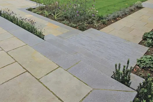 Antique Grey Limestone Steps integrated into a garden path, surrounded by planting and light-toned paving.