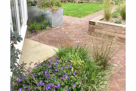 Bexhill clay pavers seen prominently in path between lawn and planter. Small section of Antique Yellow Limestone Paving near door.