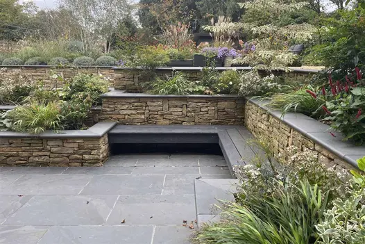 Brazilian Black Slate Bullnose Steps used for low-level garden seating and raised planters.