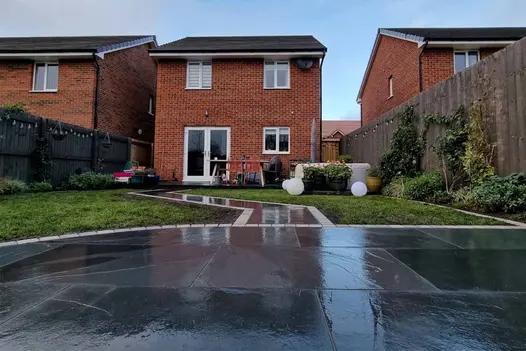 Brazilian Black Slate Paving patio area supplied by London Stone that is installed to lead into paving walk path towards the house.