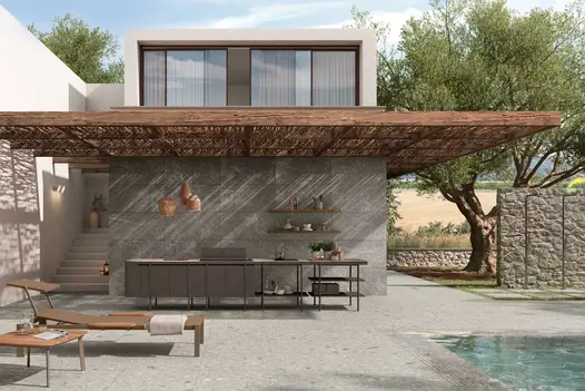 Modern building with canopy shading outdoor kitchen on Brera 800x800 Porcelain Paving next to swimming pool.