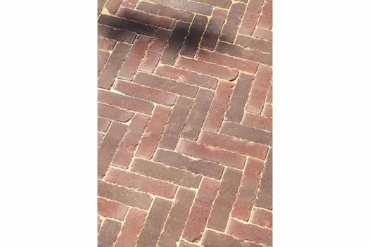 View down onto Abbey Dark Multi clay pavers laid herringbone pattern with sanded joints. Built by Utopia Landscapes.