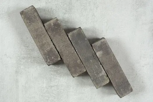 4 Moderna clay bricks placed on the slant in a row, each slightly higher than the other. Free UK delivery available.