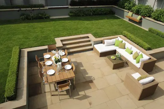 Overhead view of lawn patio of Britannia Buff sawn York stone, with steps up to lawn and coping edge. Design by Harrington Porter.