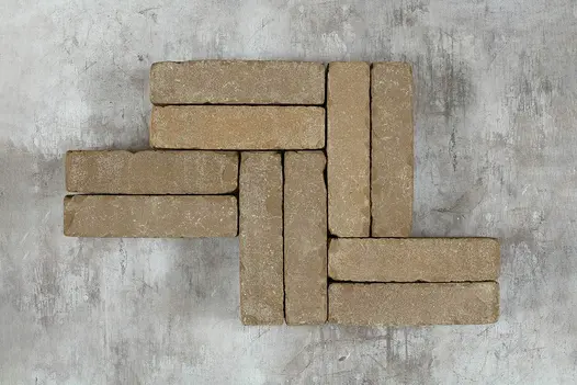 Overhead view of Antique Brown Clay Pavers arranged on grey background.