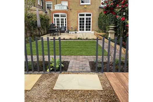 Harvest Sandstone slabs set in gravel, in front of Aldridge clay paving path between beds. Lawn beyond. Design by Robert Jackson.
