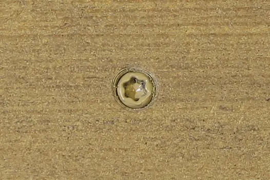 Charcoal composite decking board with Charcoal colour match screw fixed to the middle of the board. 
