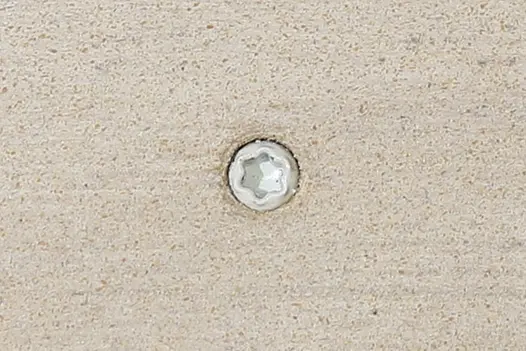 Polar composite decking board with Silver & Polar colour match screw fixed to the middle of the board.