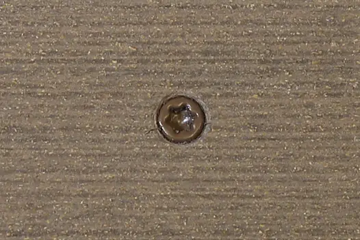 Traditional composite decking board with Traditional colour match screw fixed to the middle of the board.