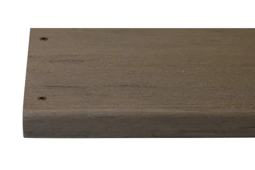 Traditional composite decking board with two Traditional colour match screw fixed to the far left face of the board.