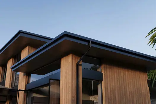 Modern property clad in Coppered Oak Millboard Shadow Line, with vertical boards and contemporary black-framed windows.