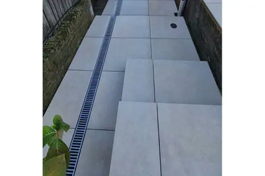 Looking down a long set of garden steps constructed from Corda porcelain with a galvanised steel drainage channel down one side.