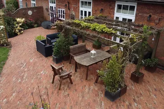 Birds eye view of traditional style garden using cotswold clay pavers, marrying up well to the red brick of the house.