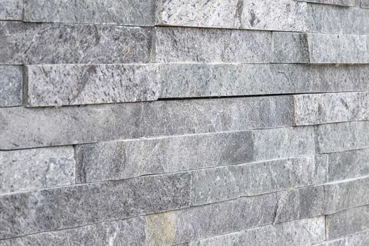 Close-up of Green slate cladding, showing colour, markings and uneven texture. Erected by Cube 1994.