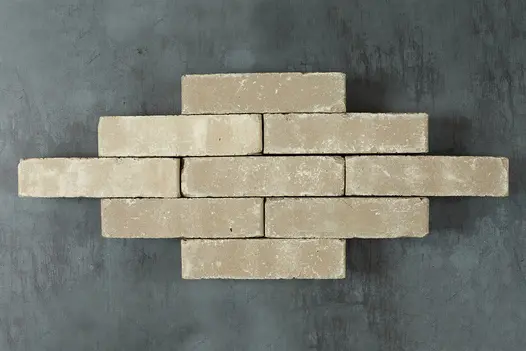 9 Gromo antica clay paving bricks, showing cream tones, placed side by side against dark background.