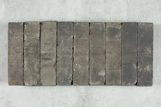 9 Moderna Dutch clay paving bricks, showing grey, white and beige tones, placed side by side against pale background.