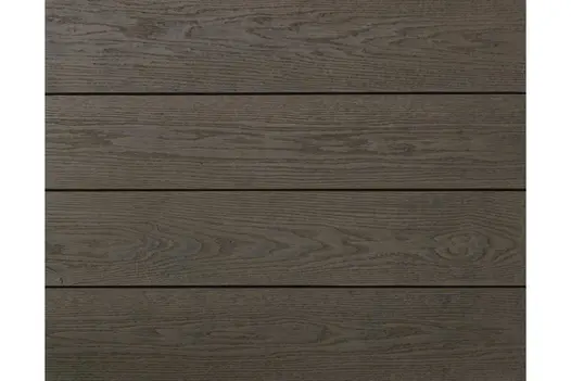 Wide view of Ebony Grey Millboard composite decking, showing deep grey tone and weathered wood-effect texture.