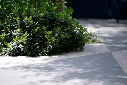 Close-up perspective revealing the intricate details of trendy black and urban grey porcelain tiles with angular cuts.