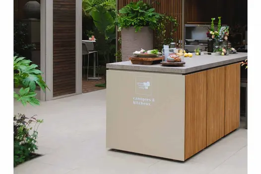 Egyptian Beige Porcelain tiles provide a clean, neutral floor across a relaxed garden entertaining area at RHS Chelsea 2025.