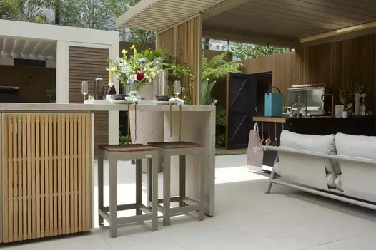 Egyptian Beige Porcelain Paving used beneath outdoor kitchen and stools in a contemporary garden design at RHS Chelsea.