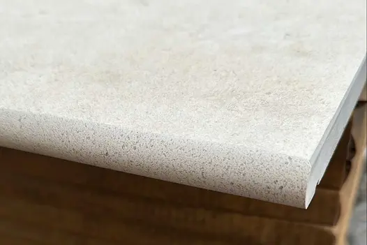 Side profile of one florence beige 20mm moulded bullnose step. Available off the shelf and with free UK delivery.