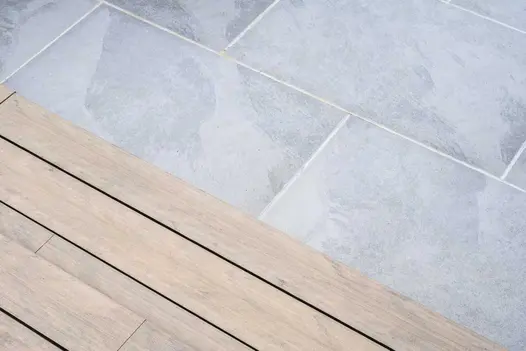 Close view of 2 steps of DesignBoard Traditional down to Florence Storm porcelain tiles with white grout. Laid by Acacia Gardens.