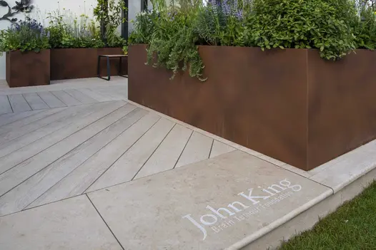 Jura Beige bullnose limestone step tread and Millboard decking surround Corten Steel planter. Design by Rhi Williams, Garden Club.