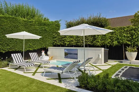 Modern garden designed and built by PWP Landscapes with Comblanchien Porcelain Paving supplied by London Stone nationwide.