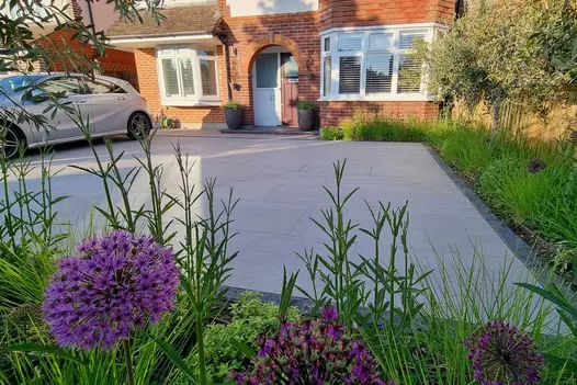 Fisheye lens type view of Kandla Grey Porcelain paving used on large driveway surrounded by planting.