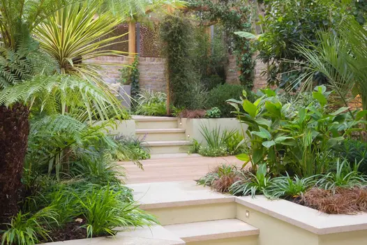 2 levels of walled garden, each area edged by retaining walls topped with Golden Stone porcelain coping stones to match steps.