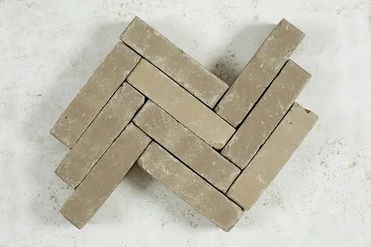10 Gromo Antica clay pavers laid edge-on in herringbone pattern against white cement background. Free UK delivery available.