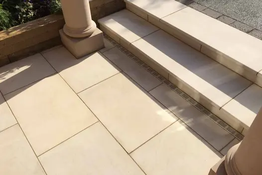 Path with 2 classic pillars either side of 2 Beige Sawn sandstone bullnose steps up. Design by Hortus Landscape and Design.