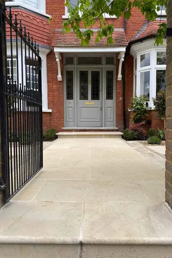 Harvest Sawn Sandstone Bullnose Step and matching paving, shows an elegant entrance leading to the front door.