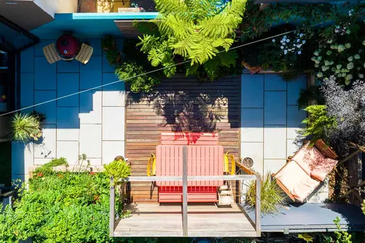 Aerial view of colourful garden using Light Grey Porcelain Paving patio with wooden decking in between.