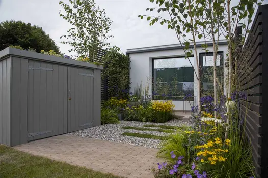 Stone Grey clay pavers with mixed gravel, grass stepping stones and yellow and mauve blooms at Tatton Park. Design by Lynn Cordall.