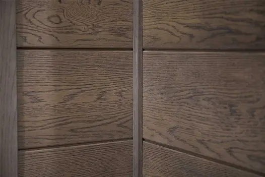 Close-up of Millboard Shadow Line Internal Corner, showing the joint detail and realistic wood-effect grain on composite cladding.