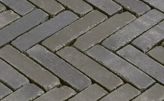 Close-up of wet Moderna Dutch clay pavers laid herringbone, showing grey and beige colours. Free UK delivery available. 
