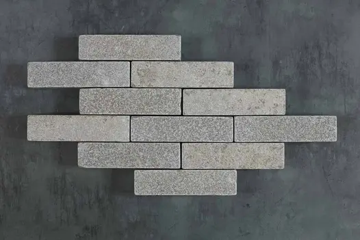 11 Antique Grey limestone patio bricks laid in 6 rows of varying lengths on a dark background. Free UK delivery available.