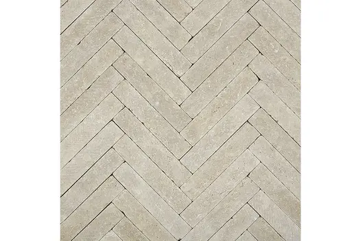A larger herringbone arrangement of Antique Egyptian Beige Limestone Pavers, showing seamless interlocking and subtle colour variations.