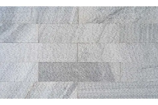 Pearl Grey Granite Cladding laid in a staggered pattern, with subtle tone variations and a linear texture.