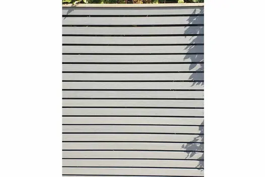 Close view of Pebble Grey Composite Battens attached as horizontal slats to garden screen framed in contrasting colour in brown.