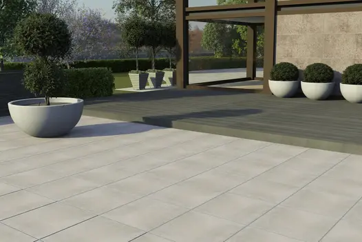 Digital render of a large contemporary garden featuring a large polished concrete porcelain patio and adjoining raised composite deck.