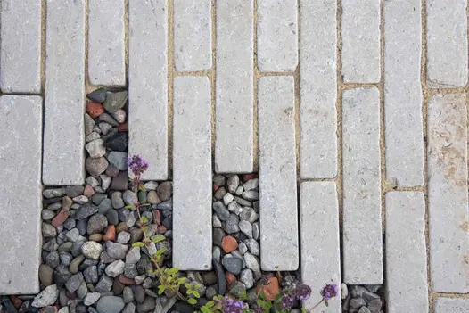 Staggered egyptian beige limestone setts seen from above at RHS Tatton Park 2024. Design by Callum Corrie.