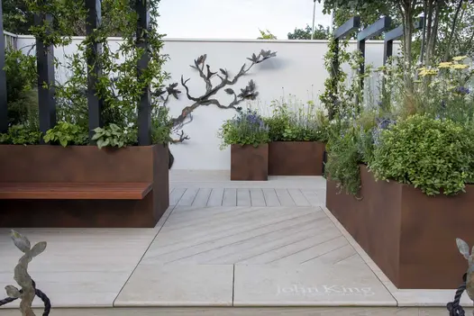 John King Brain Tumour garden, RHS Hampton Court 2022, laid with limed decking edged with Jura Beige bullnose limestone step.